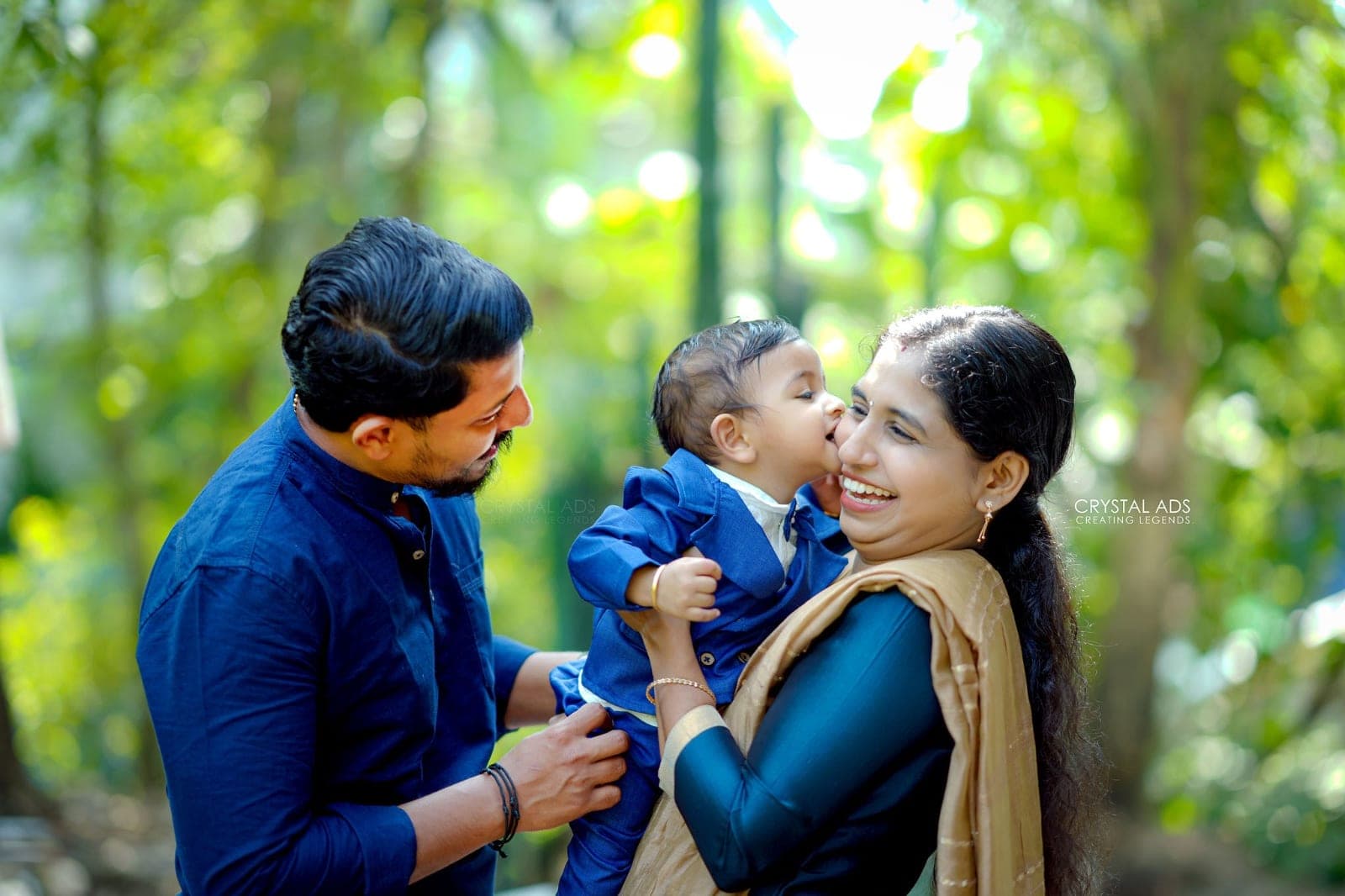 Parents laughing with their baby between them
