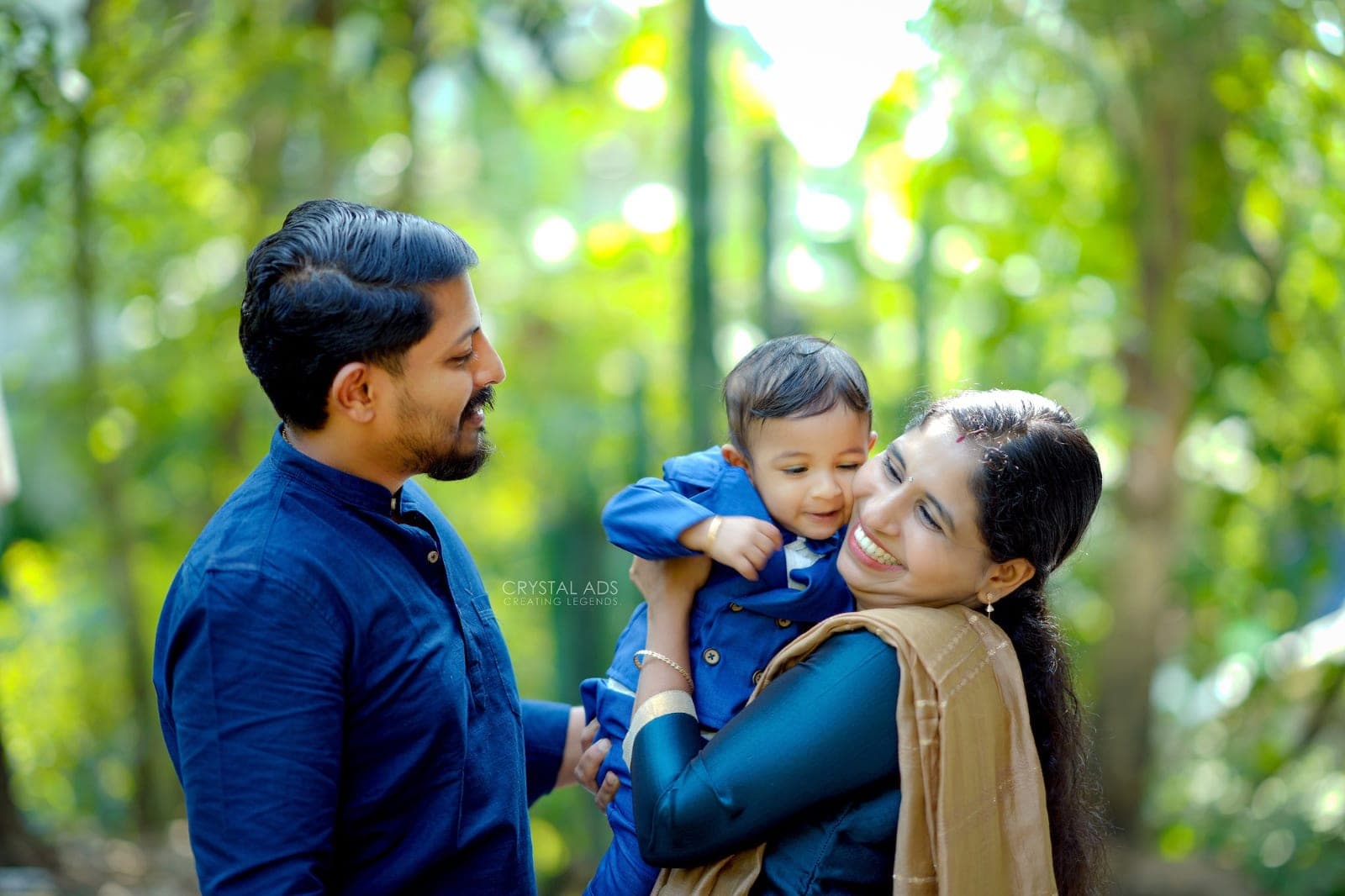 Parents holding their baby boy and smiling at each other