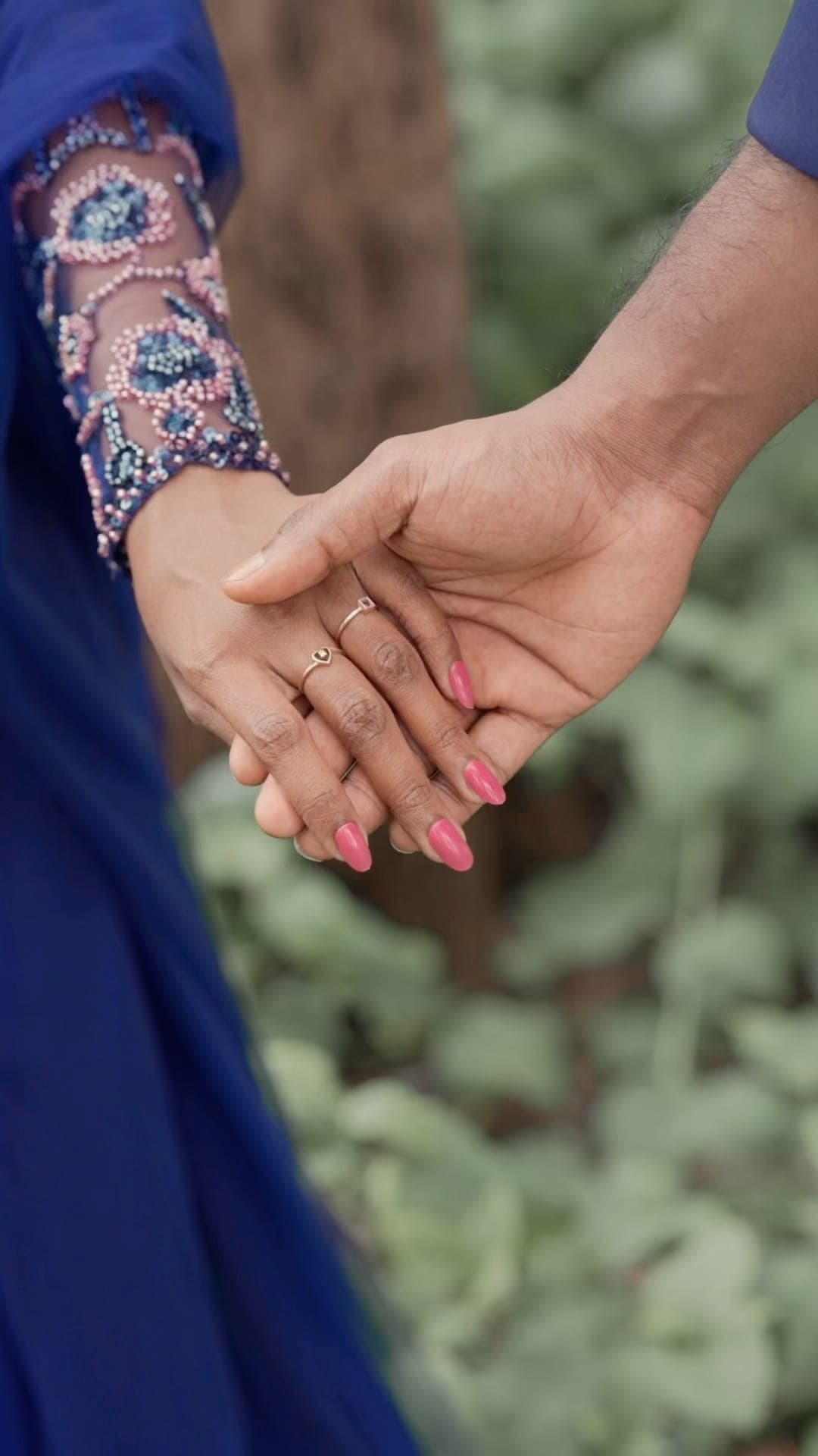 Close-up of an engaged couple holding hands