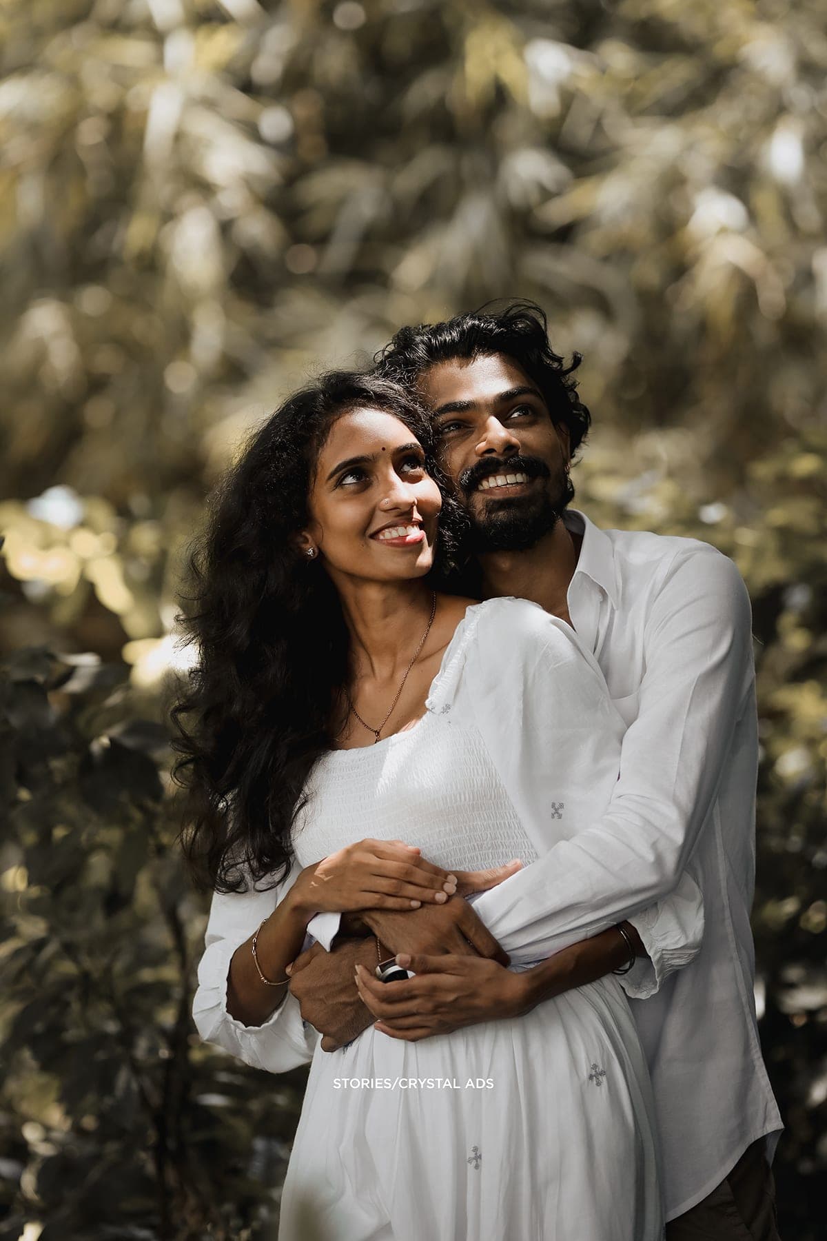 Couple laughing together, his arms around her