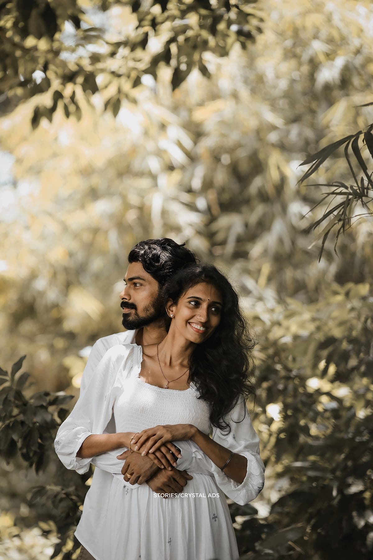 Couple embracing under golden foliage