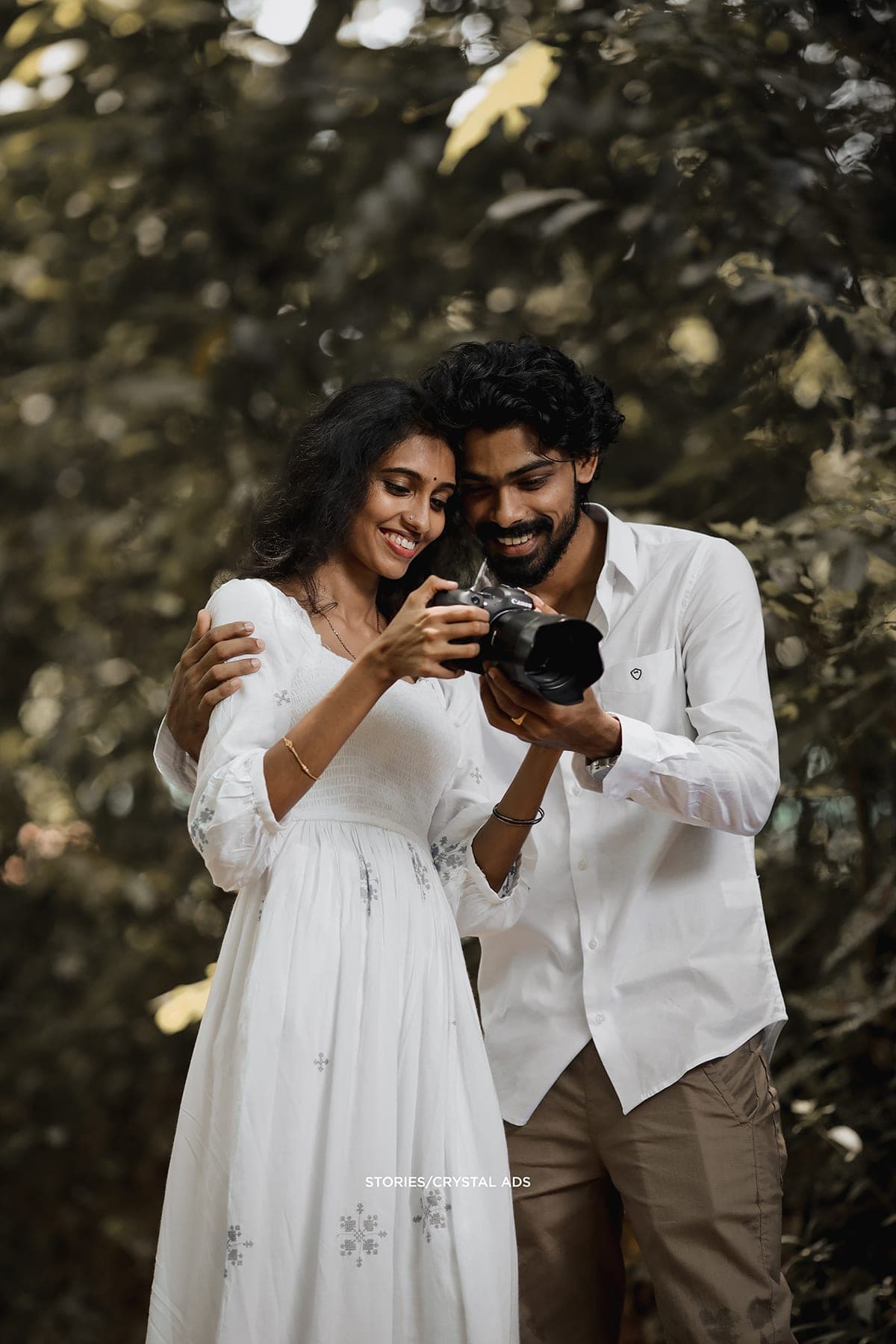 Couple looking down at the camera screen together