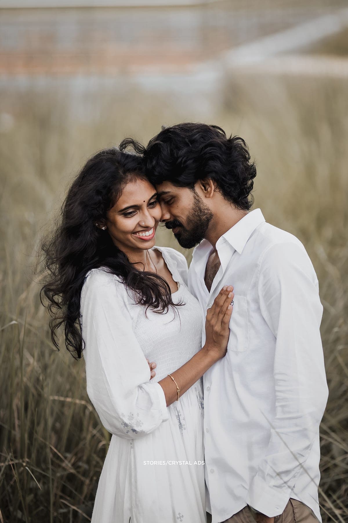 Couple forehead to forehead, her hand on his chest
