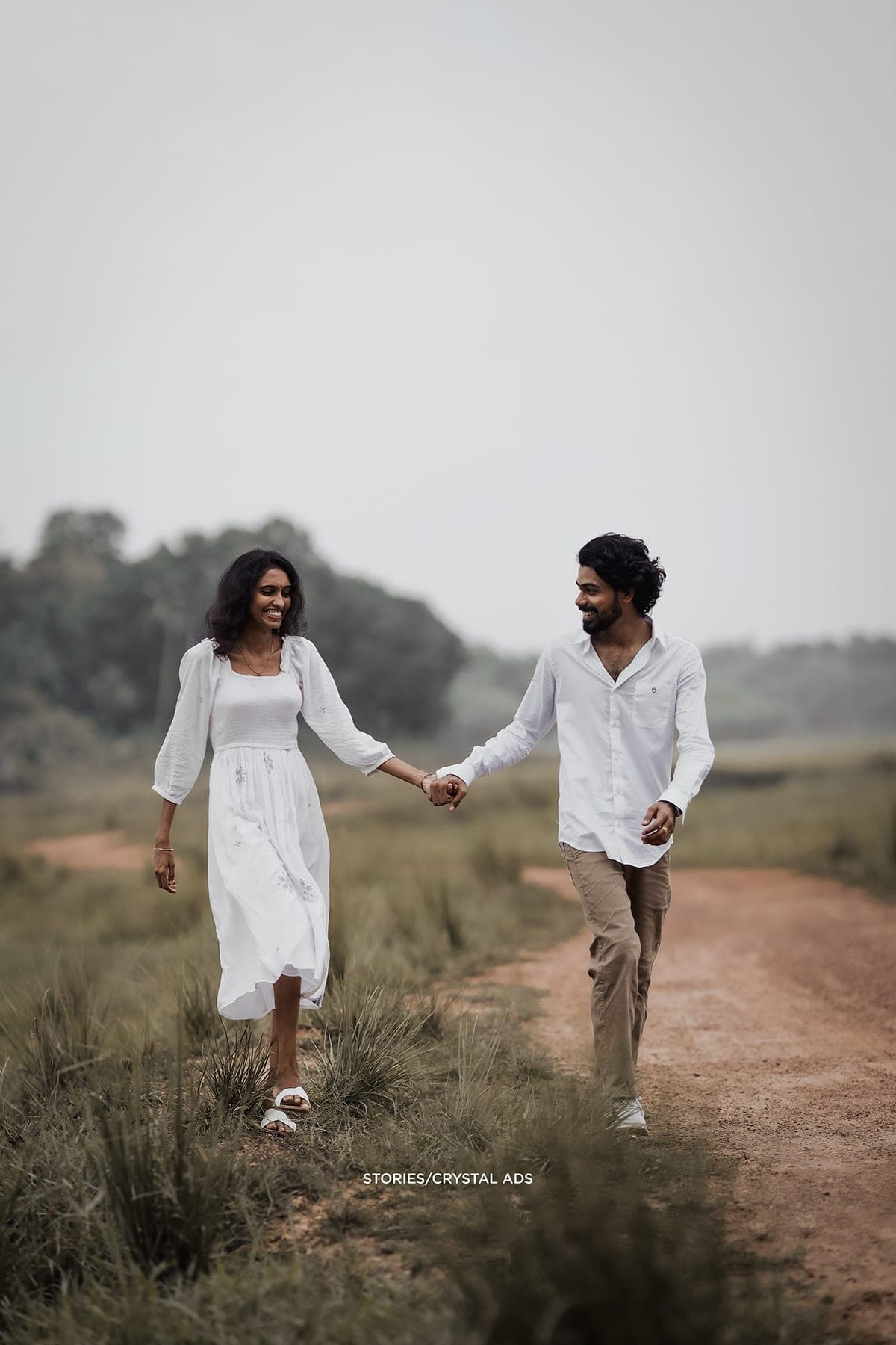 Couple walking toward the camera, hand in hand