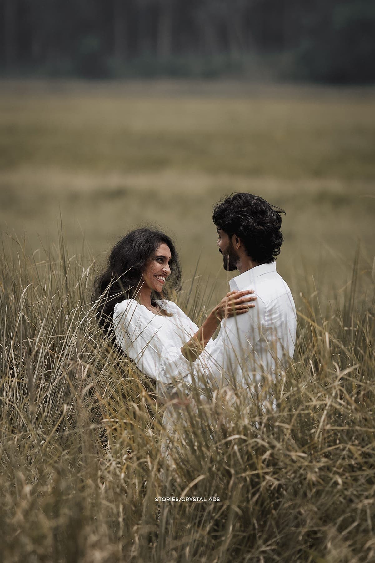 Couple laughing in waist-high grass