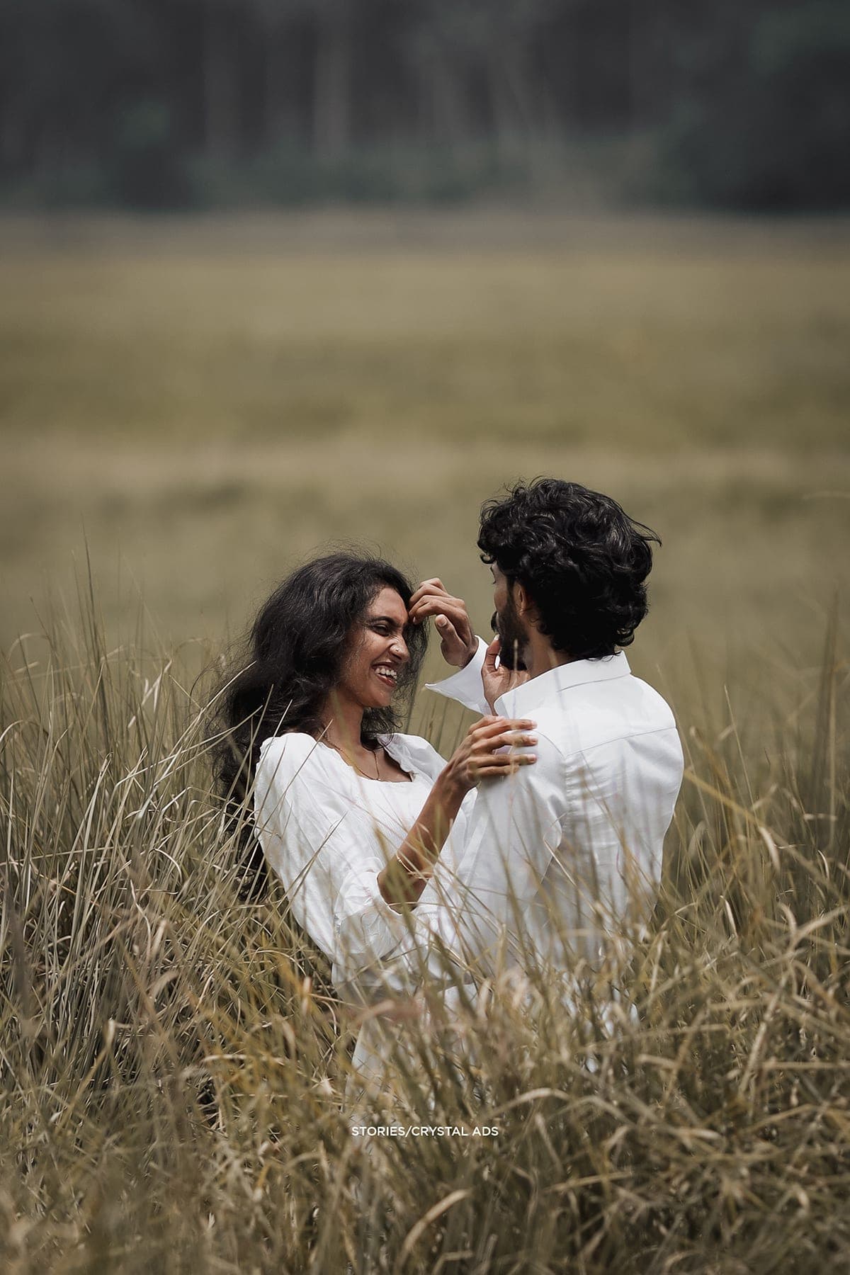 Couple embracing in tall grass