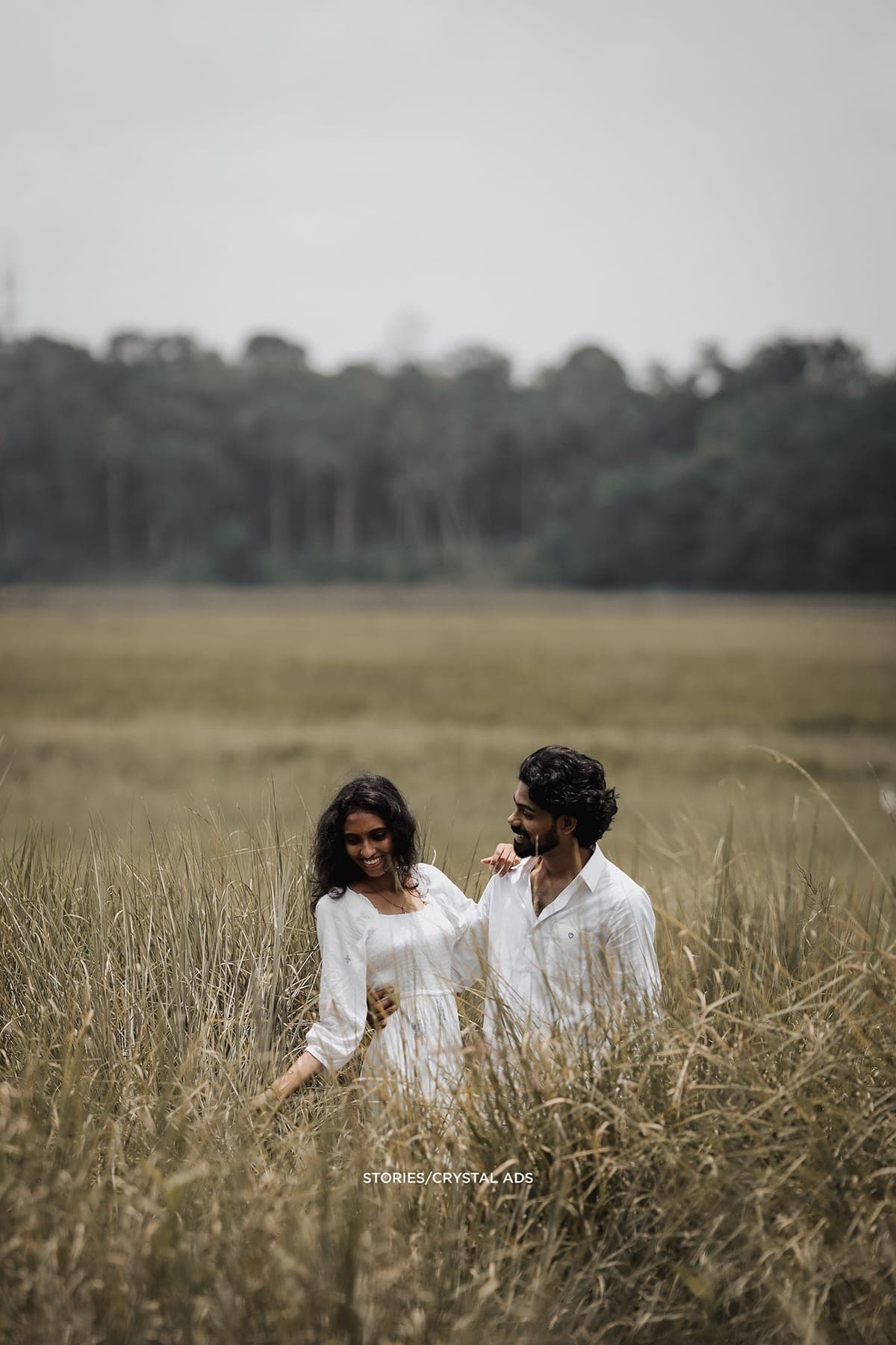 Couple sitting low in a field of grass