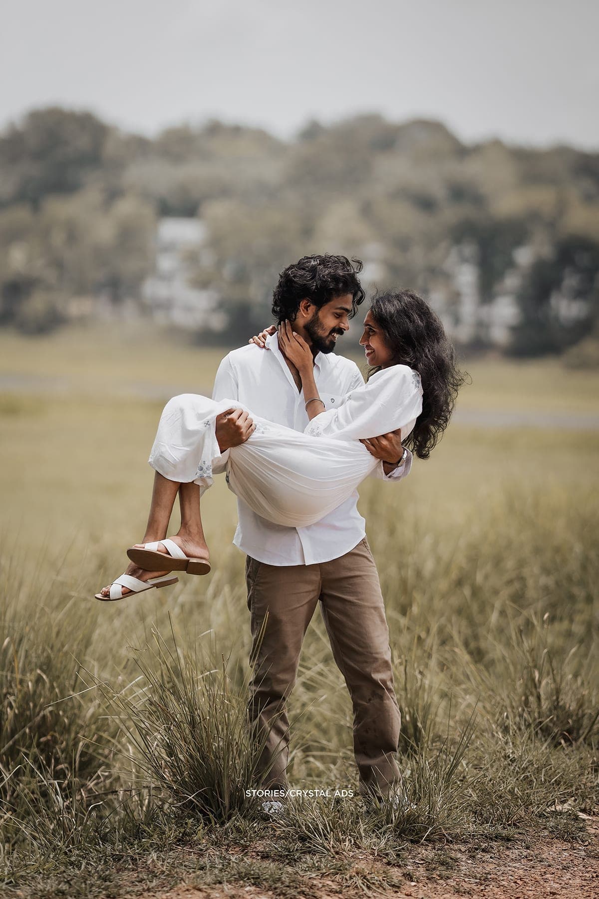 He carries her through the field
