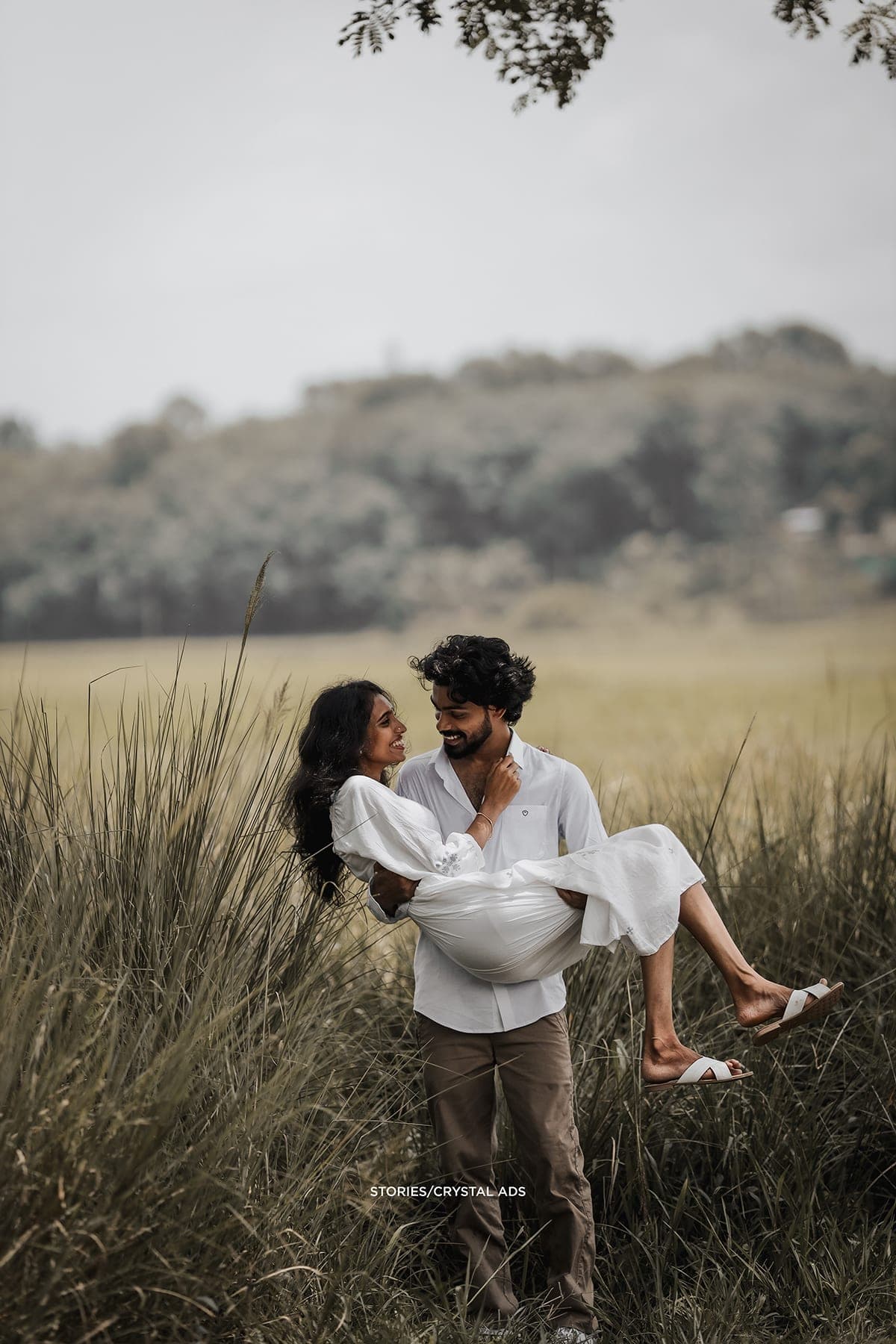 He carries her through the tall grass