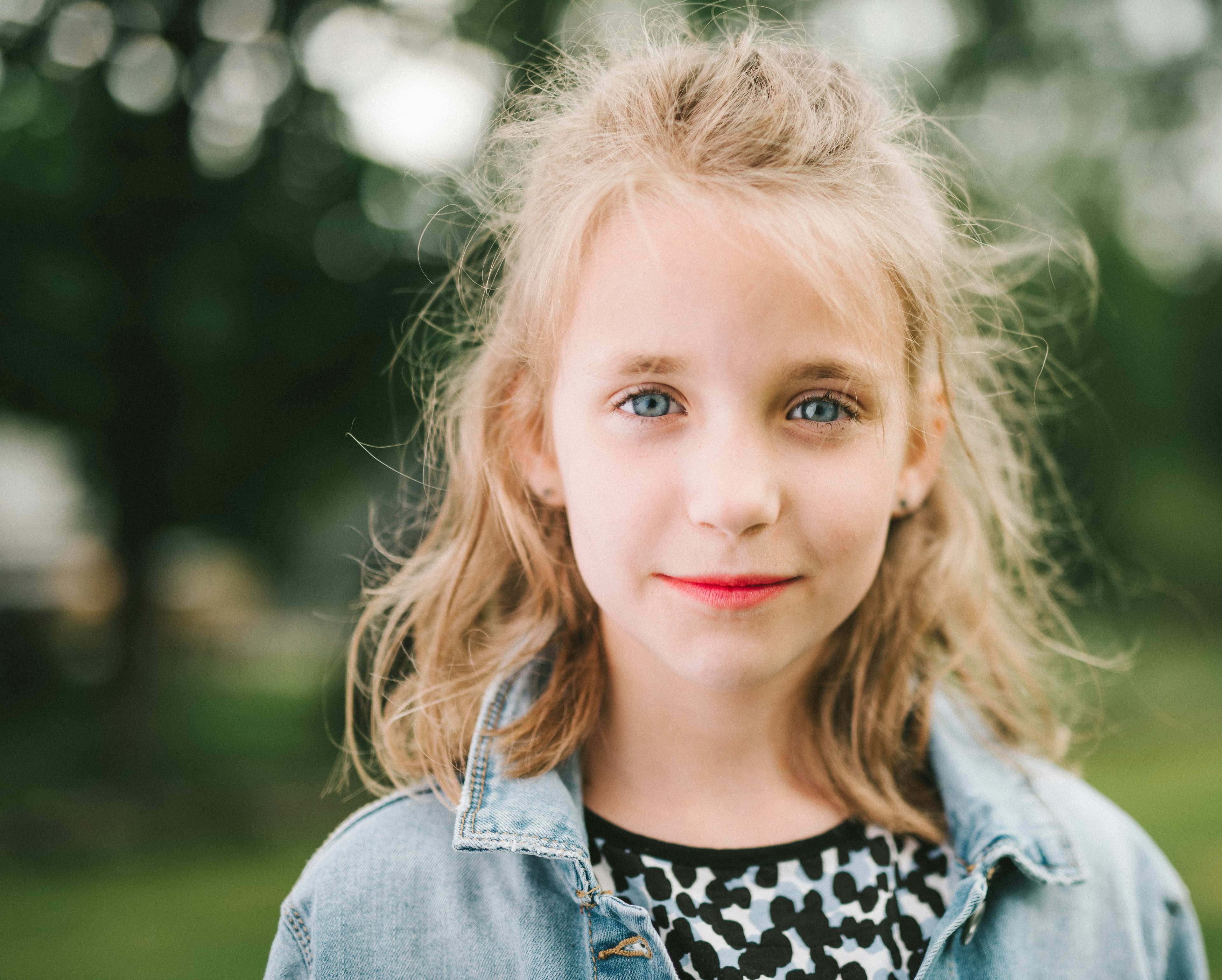Smiling girl in a blue denim jacket