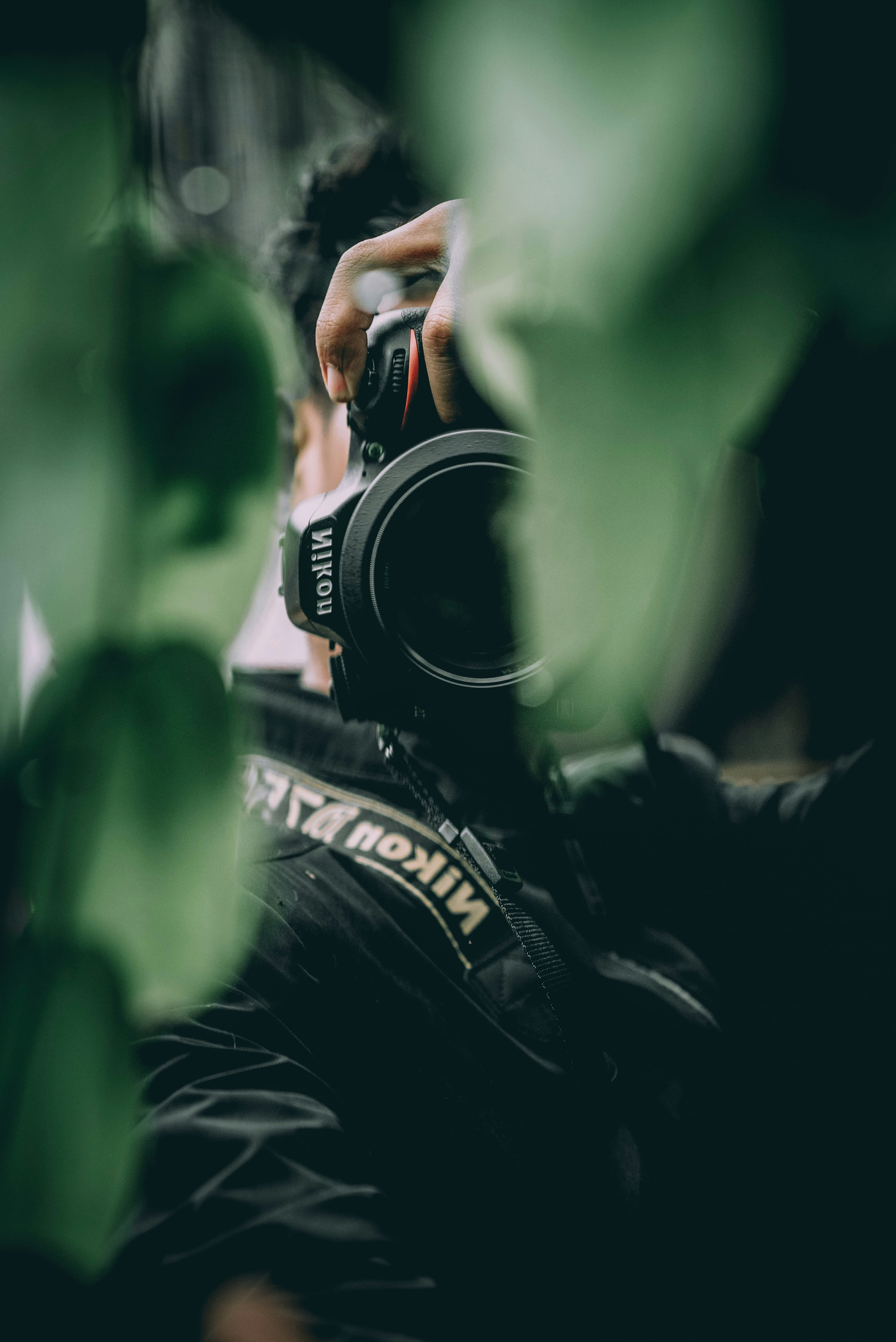 Photographer capturing a moment through a DSLR camera