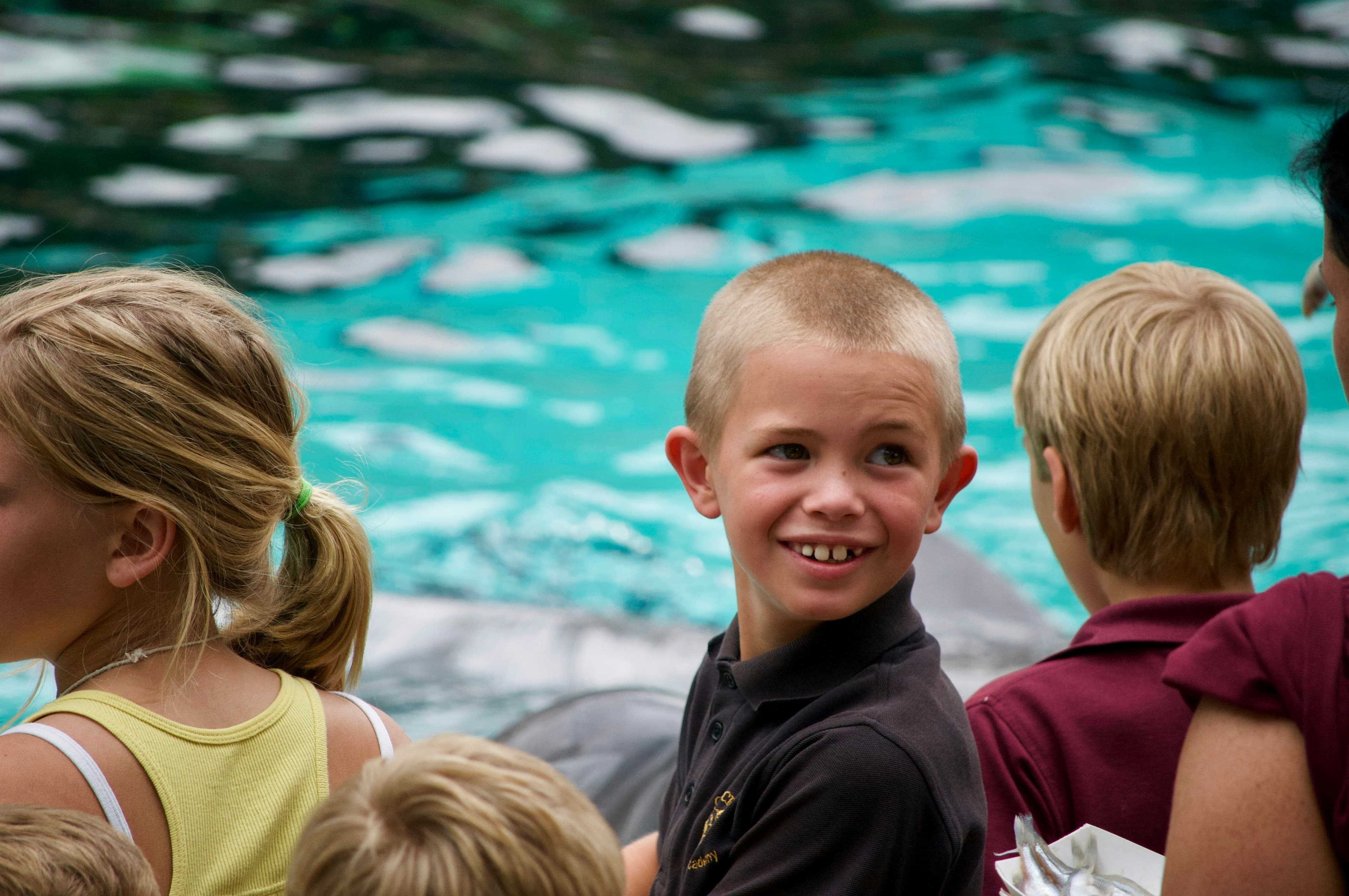 Boy smiling beside a girl in a yellow shirt