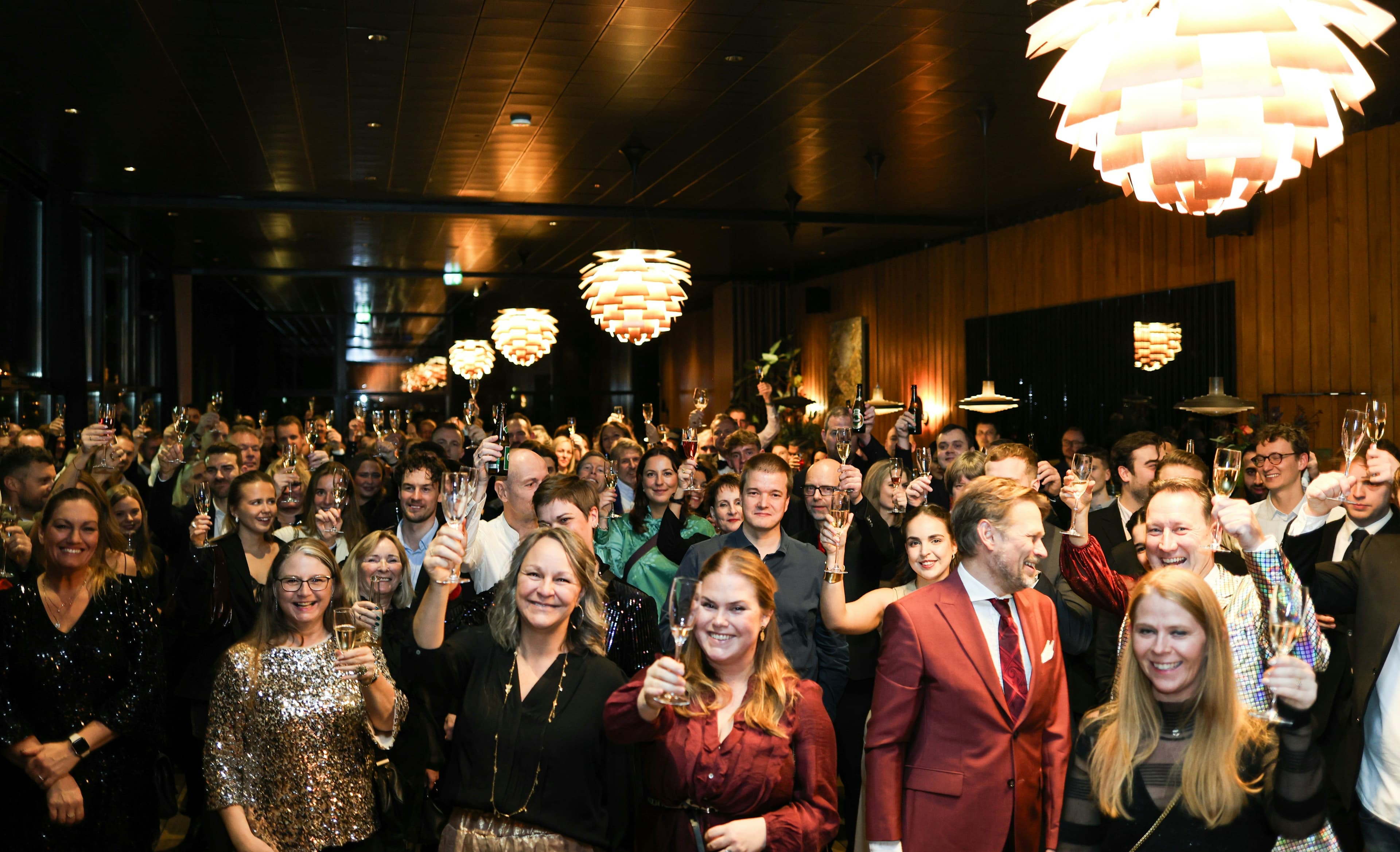 Large group of people waving at the camera