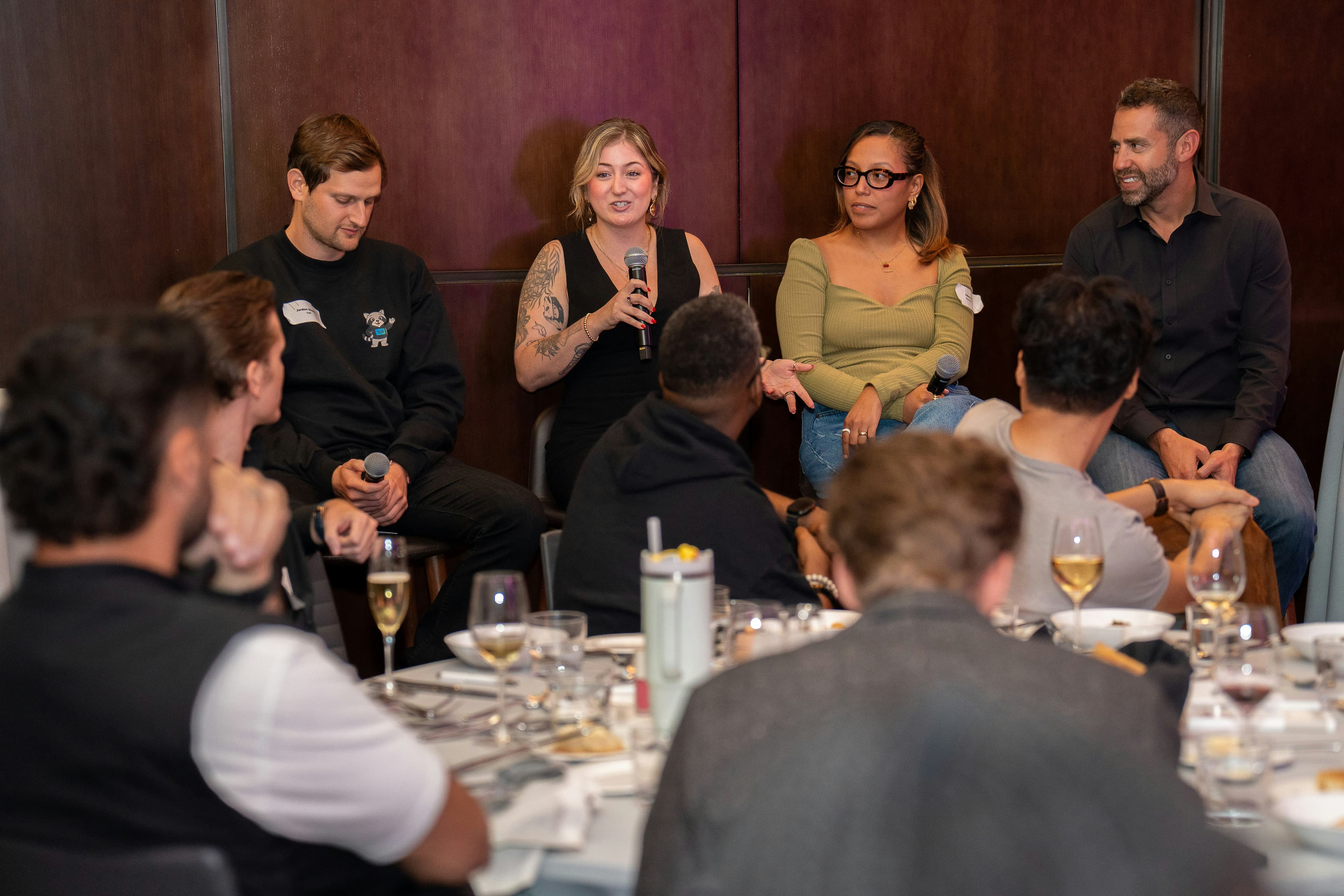 Panel discussion with speakers and audience at a table